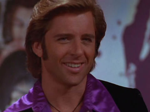 Rex Manning is kind of a meta Bad News Dude. He’s a washed up soap star, turned Rod Stewart-esque singer in Empire Records. Except not nearly as successful. He’s full of himself, a complete dick and soooooooooooo cheesy.&nbsp;
Yet. Well. When Cory BRINGS REX HIS LUNCH and he starts to take Little Rex out (sorry), I get annoyed EVERY TIME. Fucking Cory, you are a goddamn goodie two shoes! Sure his shirt is purple, and lord he’s crass, but as we learn later he’d fuck you 10 ways from Sunday on top of a copier. Who better to pop your cherry than an aging pop star wearing a choker? It’s a&nbsp;story.
Smug and smarmy dudes may be a fuck you feel guilty about later, but if you’re into self-loathing, they can work out some of your kinks. Cory should have let her ho out, I would have bent over that lunch table and accepted my punishment.